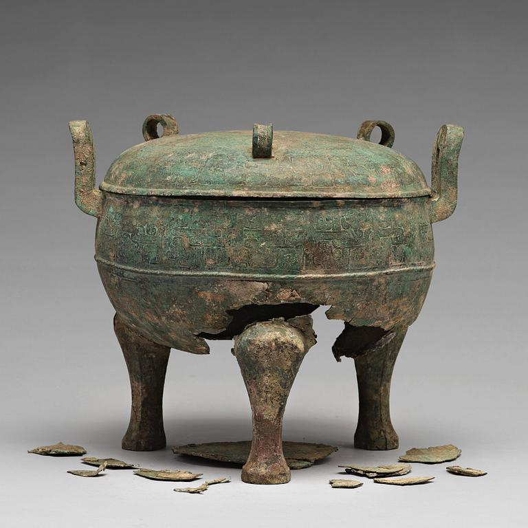 A bronze tripod food vessel and cover, "Ding", Eastern Zhou Dynasty.