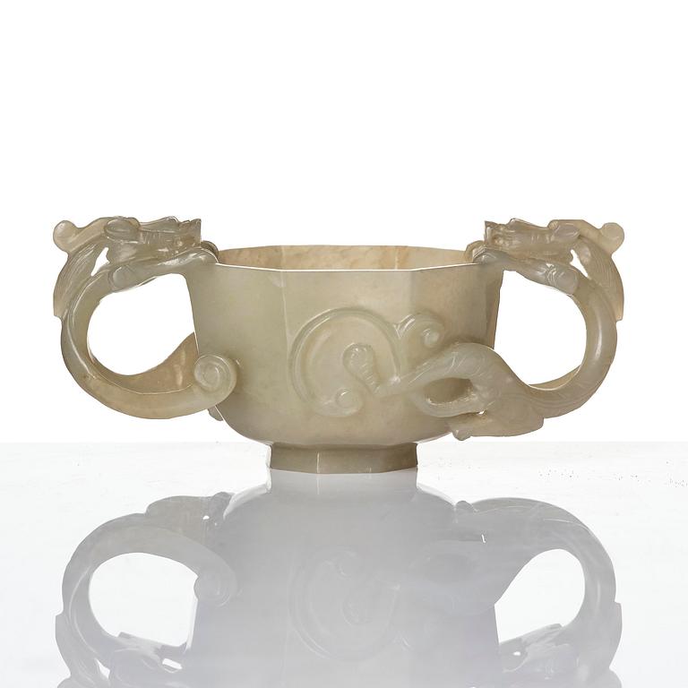 A carved nephrite cup with 'chilong' handles, late Qing dynasty/early 20th century.