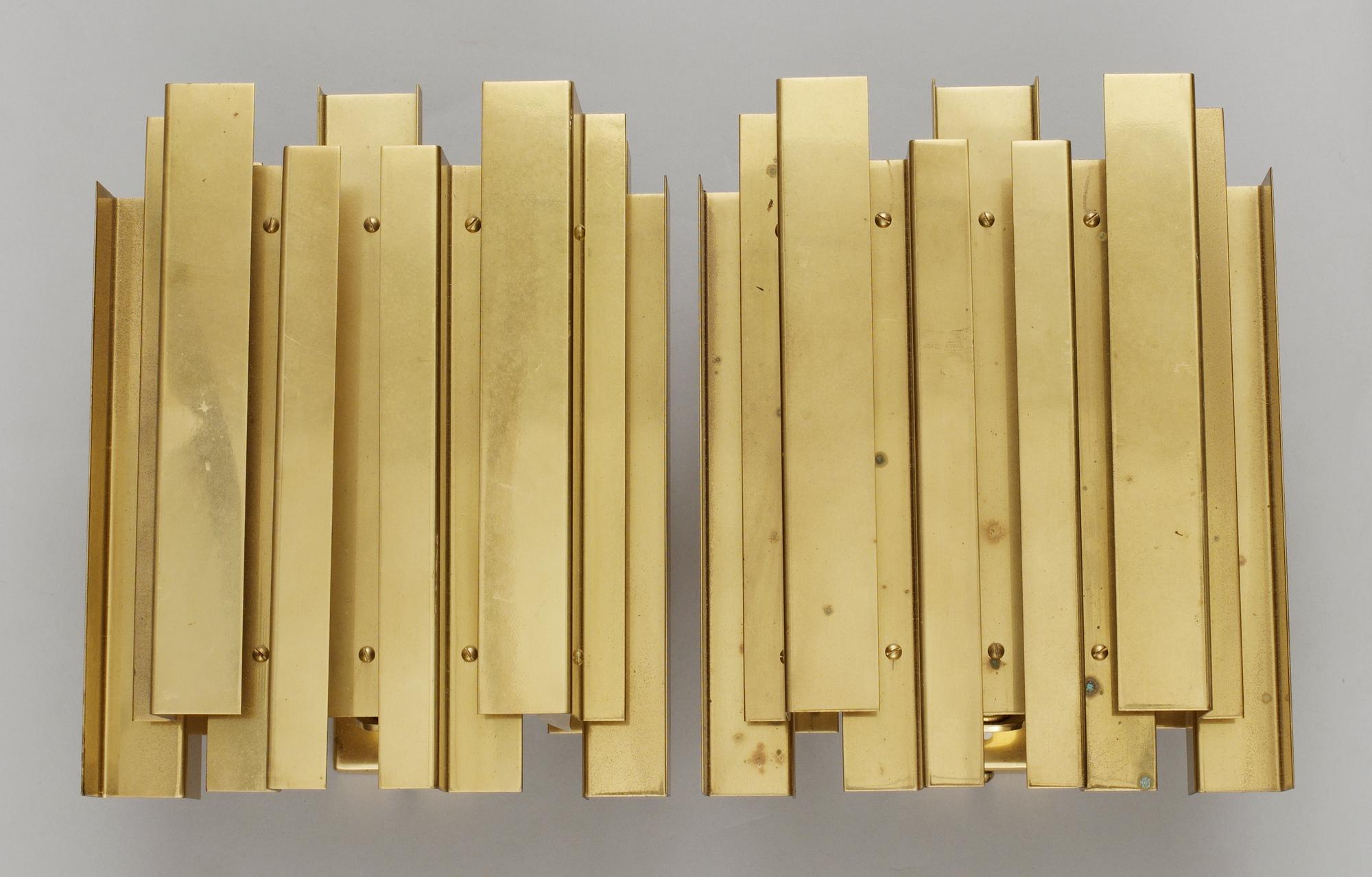 A pair of Carl-Axel Acking wall polished brass lamps probably by G Åhmans Möbelfabrik, 1960's.