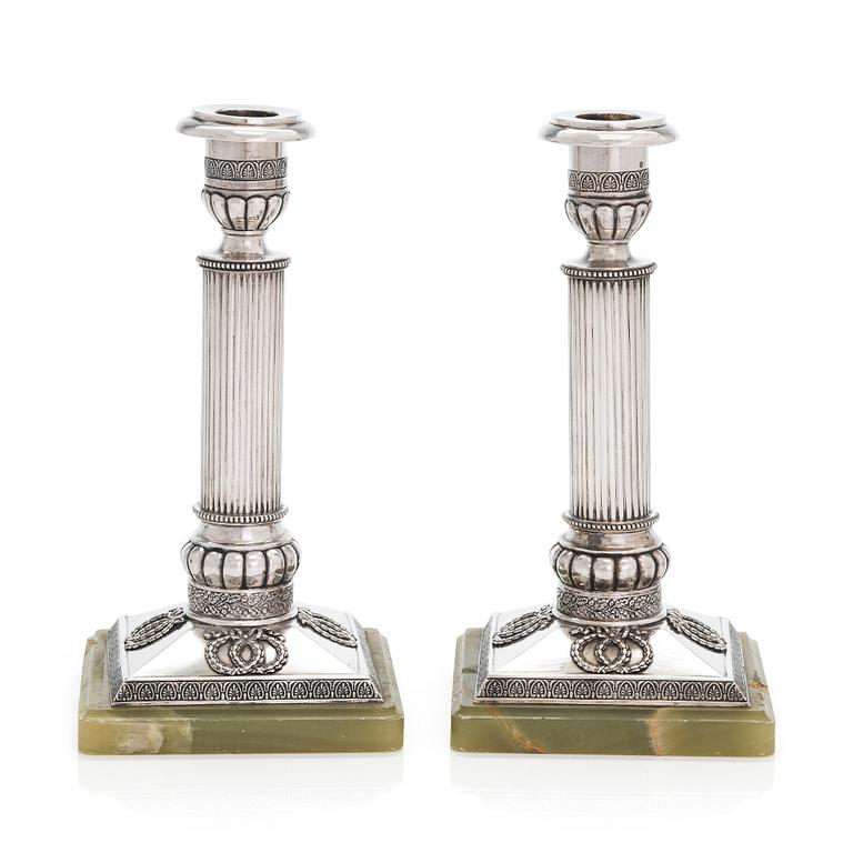 A pair of silver candlesticks, maker's mark A.T., Saint Petersburg 1908-26.