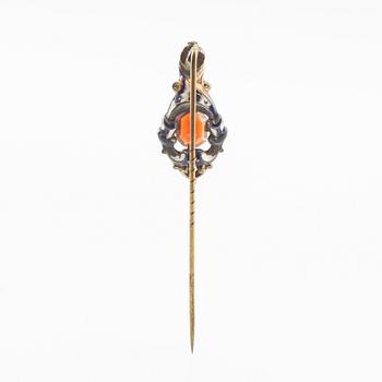 Tie pin of gilded brass with decoration of enamel and a faceted garnet, second half of the 19th century.