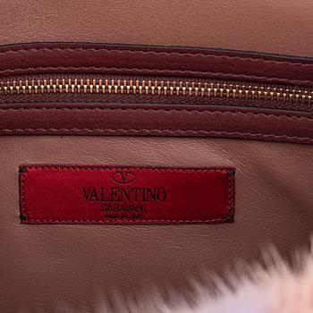 Valentino, a tinted fur, leather and studs bag.