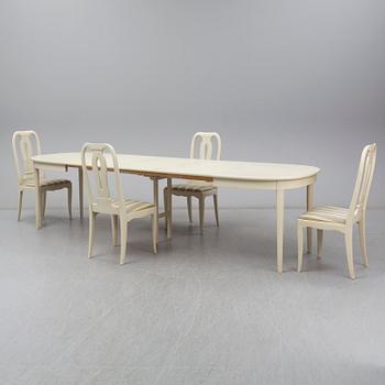 A Carl Malmsten dining table and four chairs. Three leaves included.