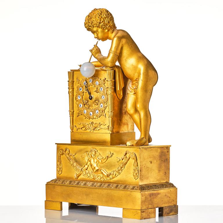 A Empire early 19th century gilt bronze " The Bubble Blower" mantel clock.