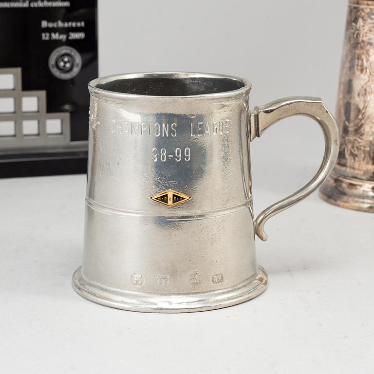 A WHITE METAL SCULPTURE, A CUP AND A BOWL.