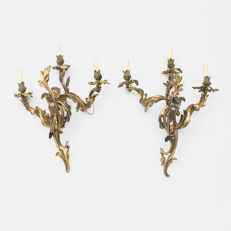 A pair of gilt-brass Louis XV-style wall-lights, circa 1900.