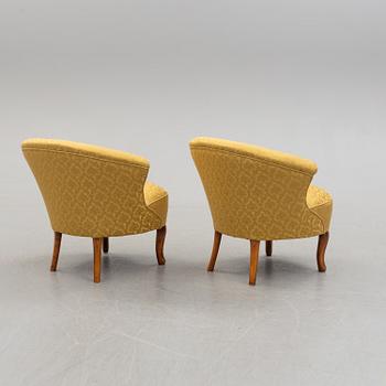 An early 20th century pair of rococo style easy chairs.