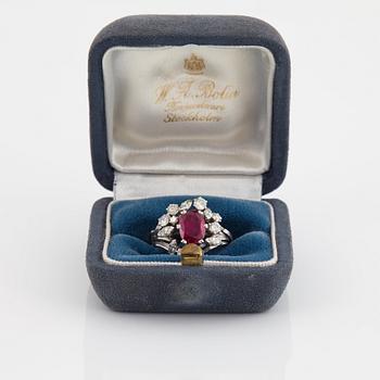 A WA Bolin ring set with a faceted pink sapphire and round brilliant- and navette-cut diamonds.