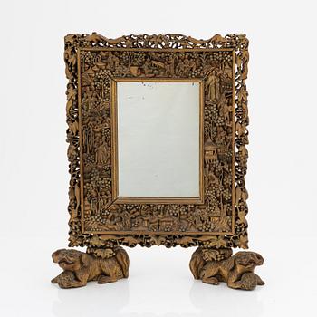 A Chinese wood mirror, 20th century.