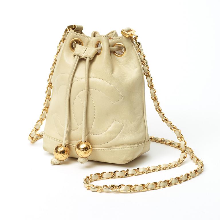 A 1980s cream colored shoulder bag by Chanel.