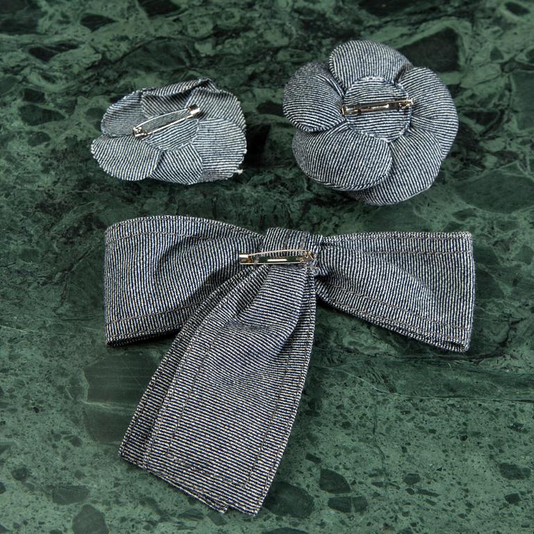 A belt and three bows, by CHANEL.
