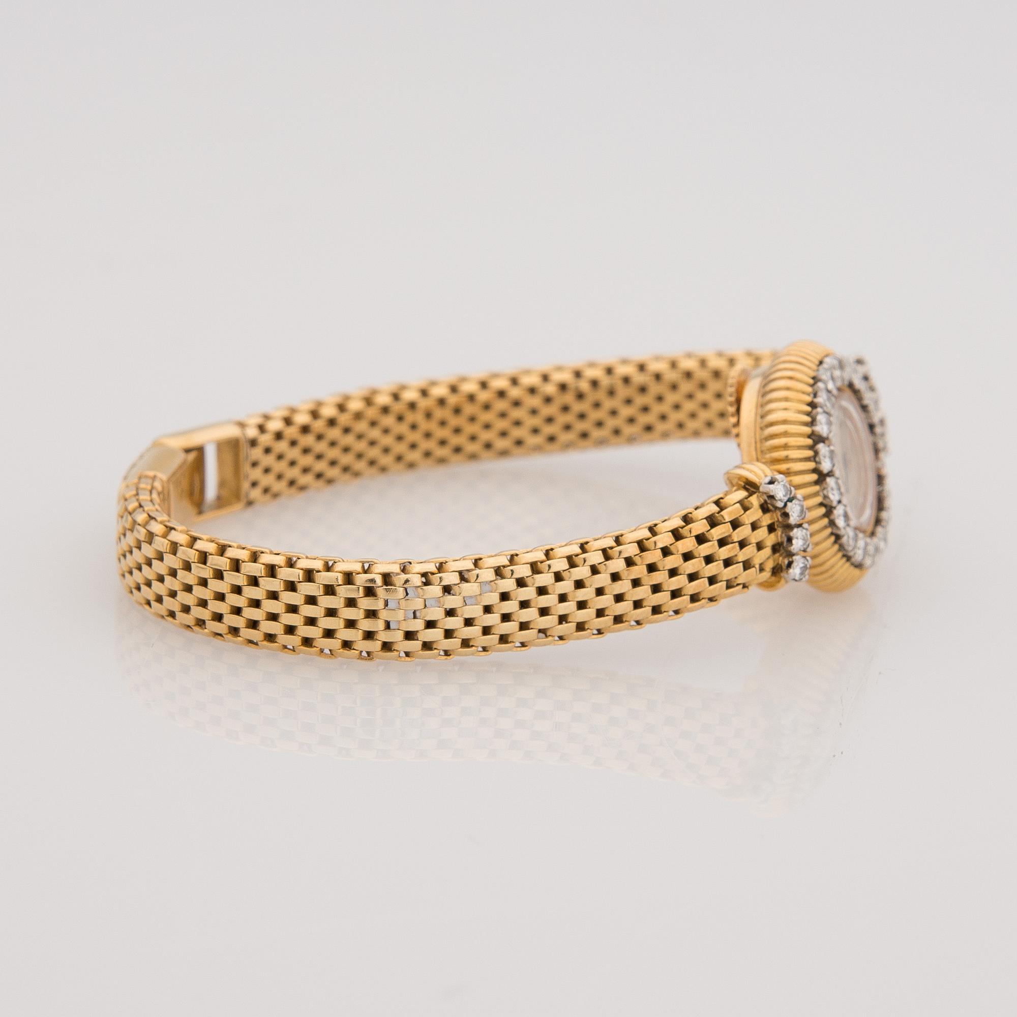 A WRISTWATCH, ladies Cartier, 18K gold, 28 pcs brilliant cut diamonds, totally c. 1,40 ct.