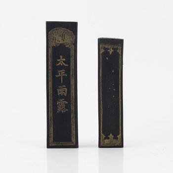 A set of four stone scholars objects and a enameled silver box with cover, Qing dynasty, circa 1900.