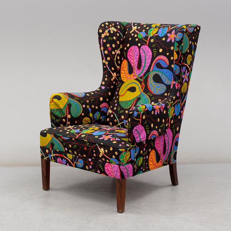 A 1960's/70's wing-chair with rosewwod legs.