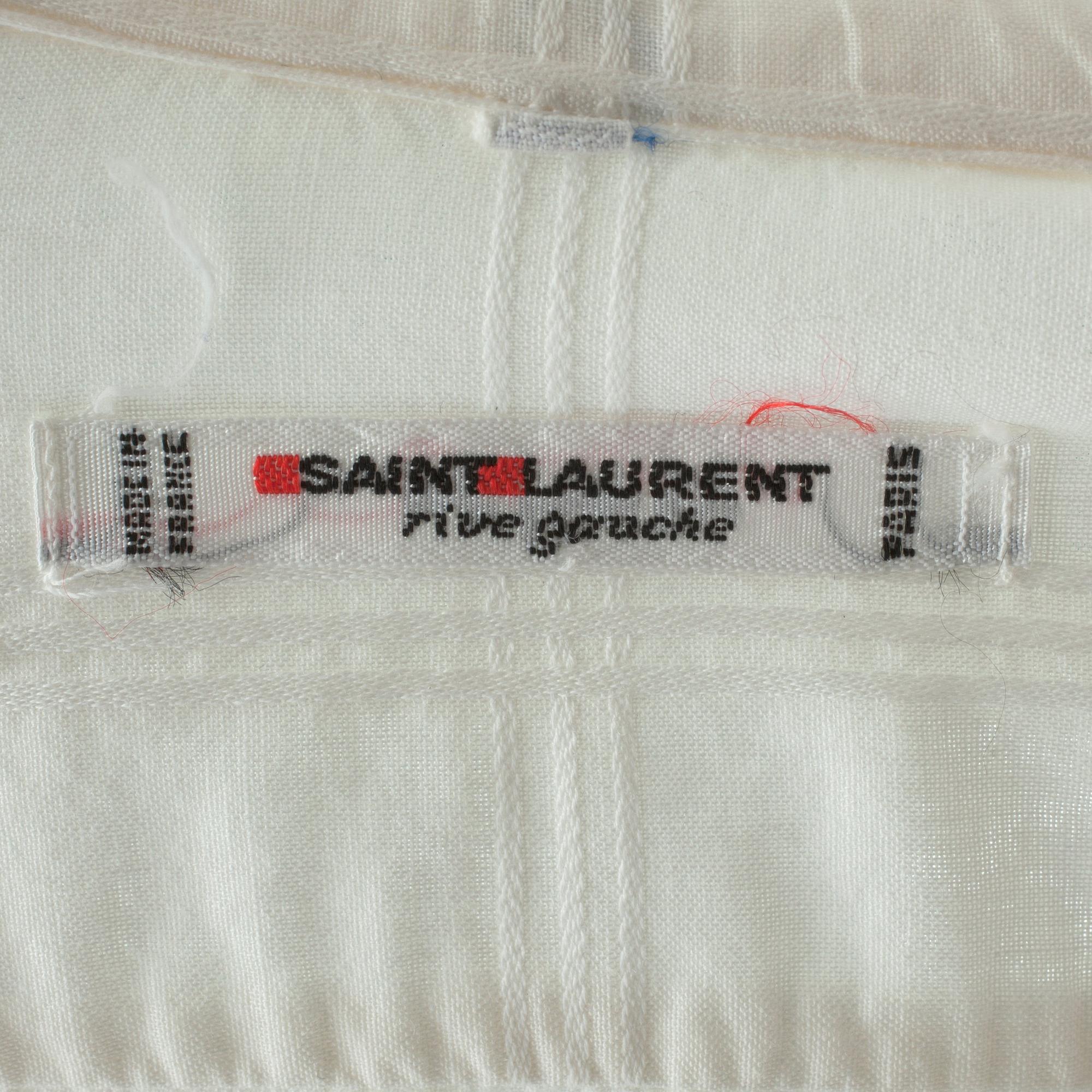 YVES SAINT LAURENT, a white cotton blouse.