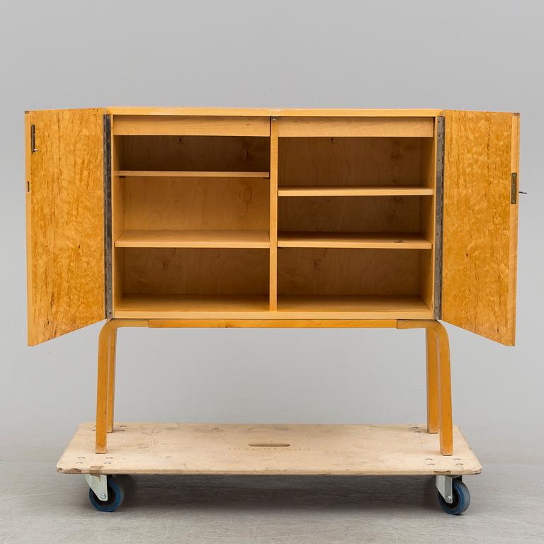 ALVAR AALTO, a mid 20th century burr birch veneered cabinet, model 810, Finland.