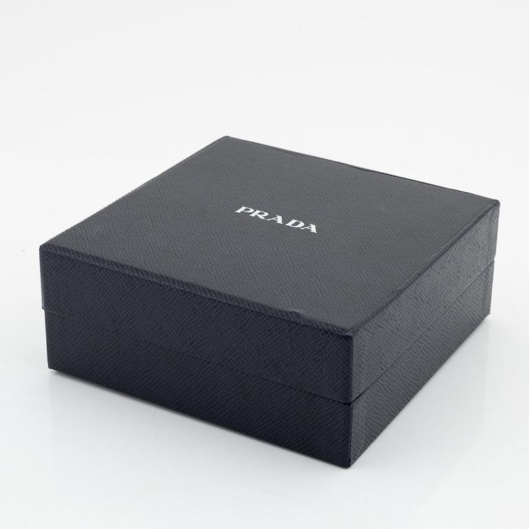 Prada, a black silk hair accessory.