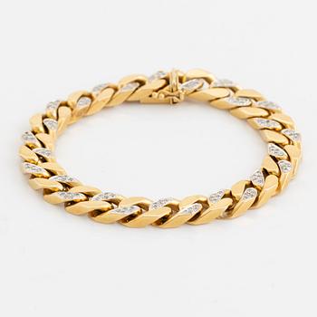 18K gold and brilliant cut diamond curb link bracelet.