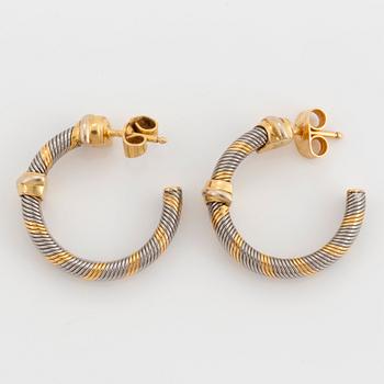 A Cartier bracelet and a pair of earrings in steel and 18K gold.