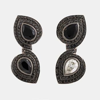 Crow's nest jewels, earrings, white gold with pear shaped diamond and black stone earrings.