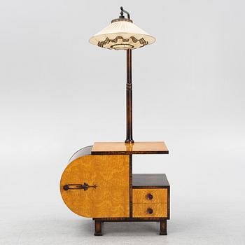 A 1930s sidetable with a lamp.