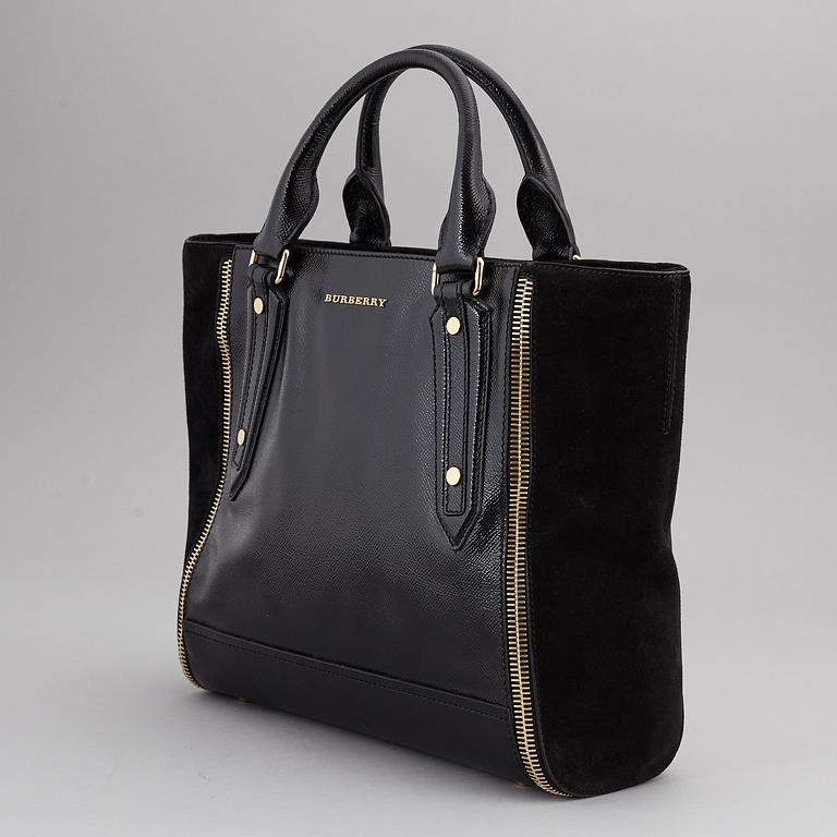 BURBERRY,  a black patent leather and suede handbag.