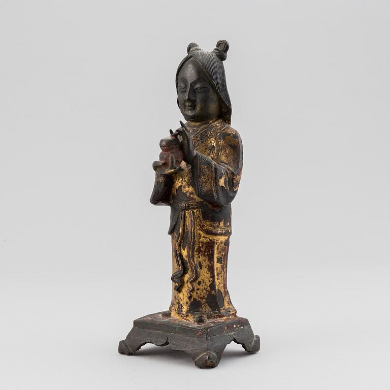 A bronze figure of a standing deity holding a jar, Qing dynasty, 19th Century.