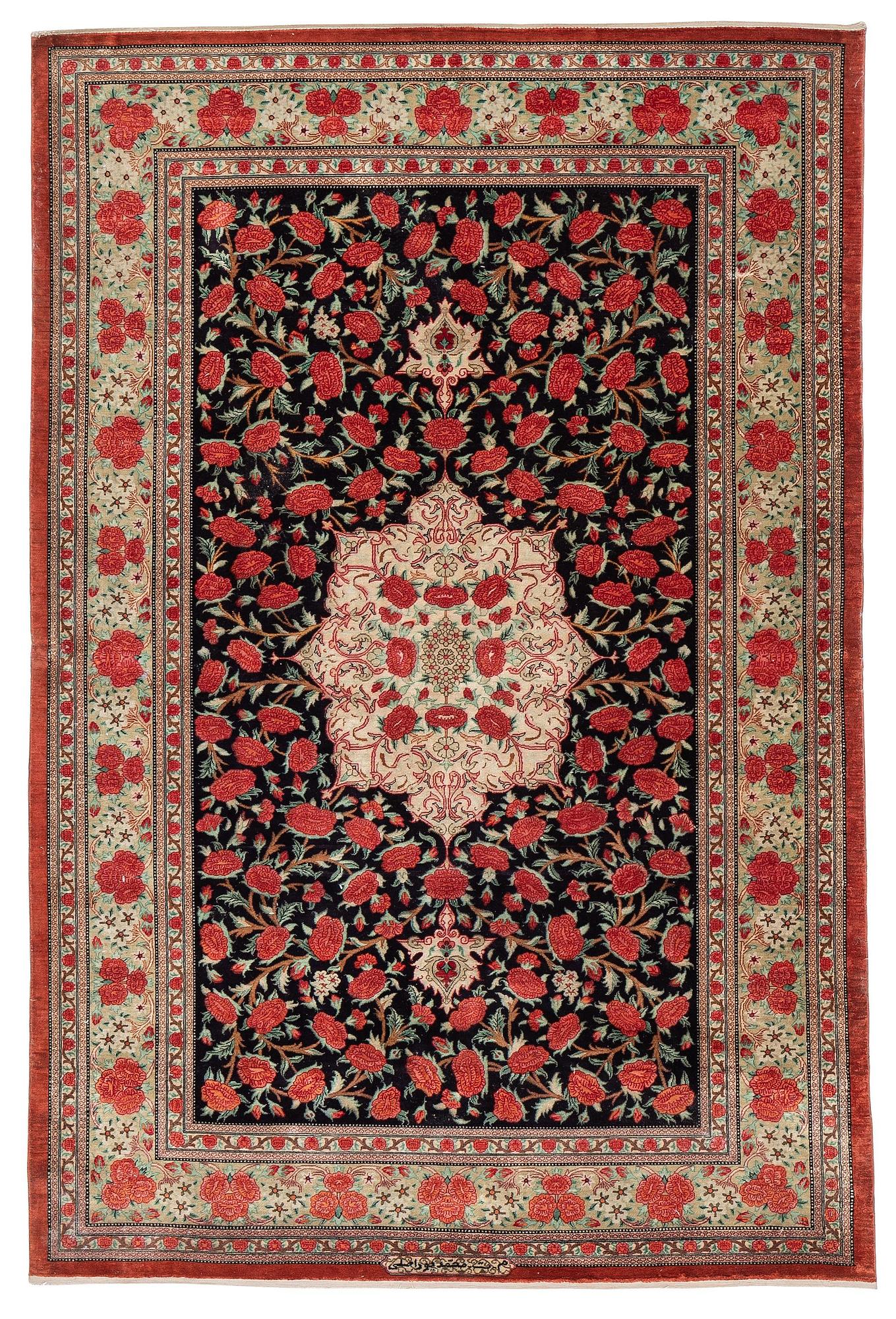 A signed silk Qum rug. c. 154 x 103 cm.