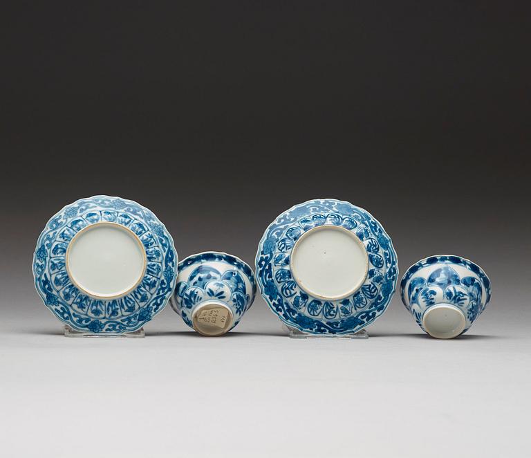 A pair of blue and white "erotic" cups with saucers, Qing dynasty Kangxi (1662-1722).