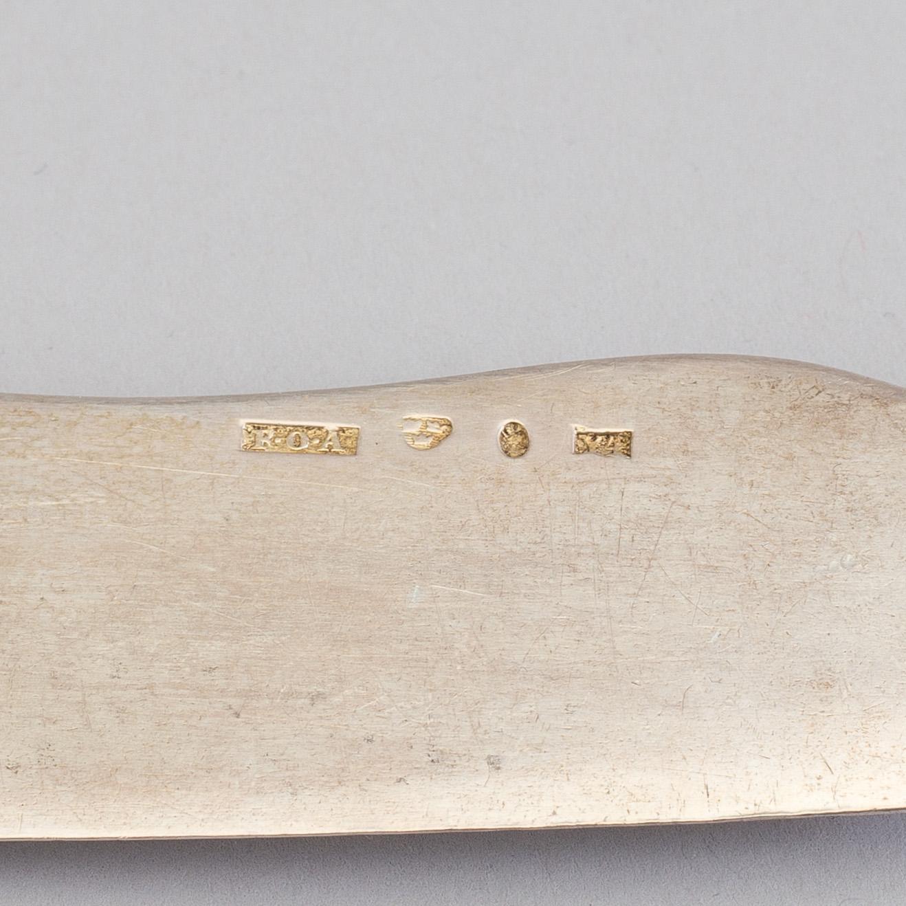A silver butterknife with porphyry shaft, dated 1853.