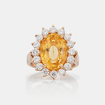 740. A yellow sapphire, circa 12.99 cts, and diamond ring.