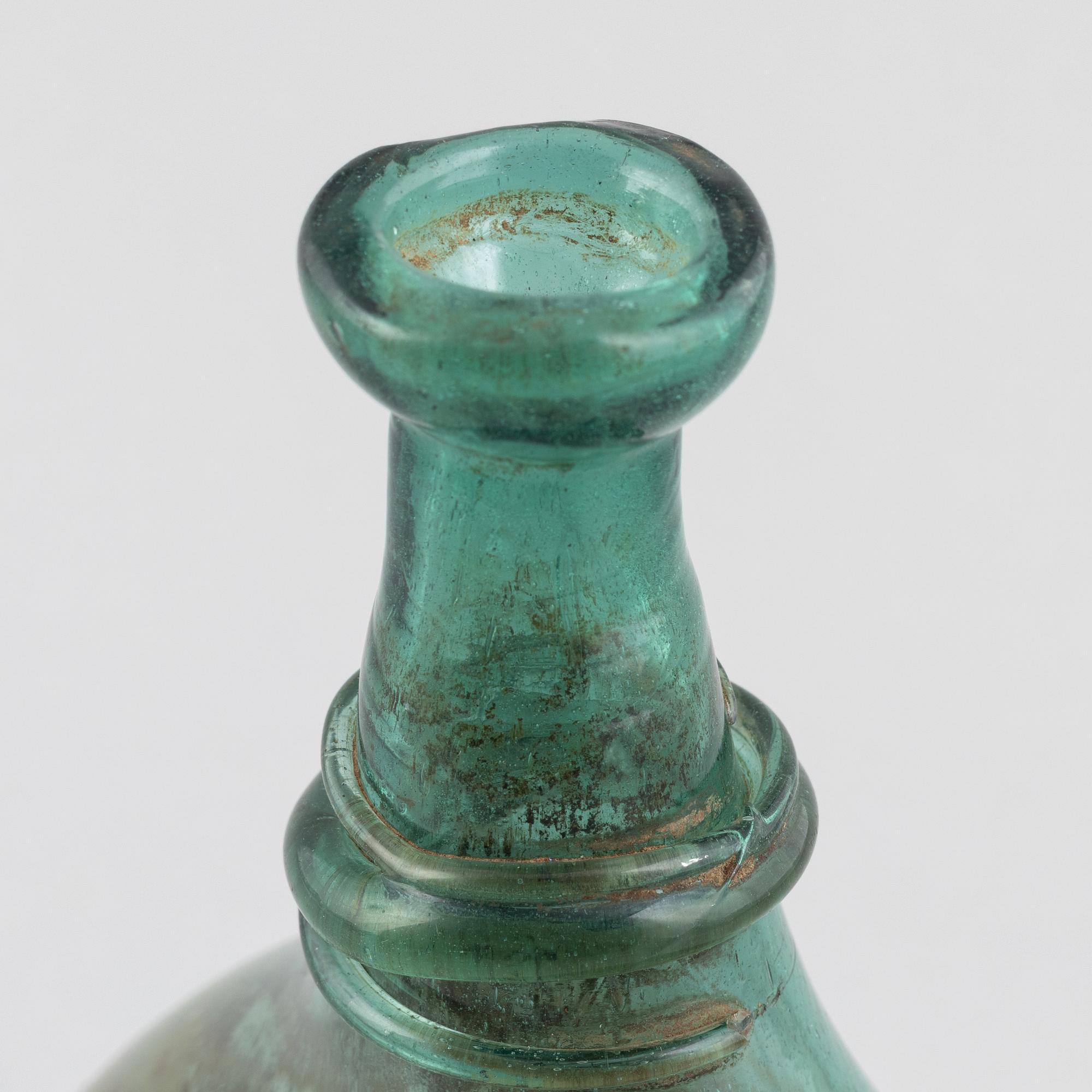 A turquoise tinted glass bottle, 19th century.