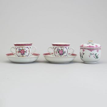 A pair of famille rose cup with stands and a sugar bowl with cover, Qing dynasty, Qianlong (1736-95).