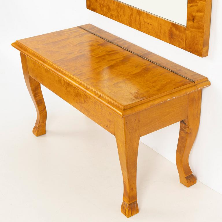 A mirror with console table, early 20th century.