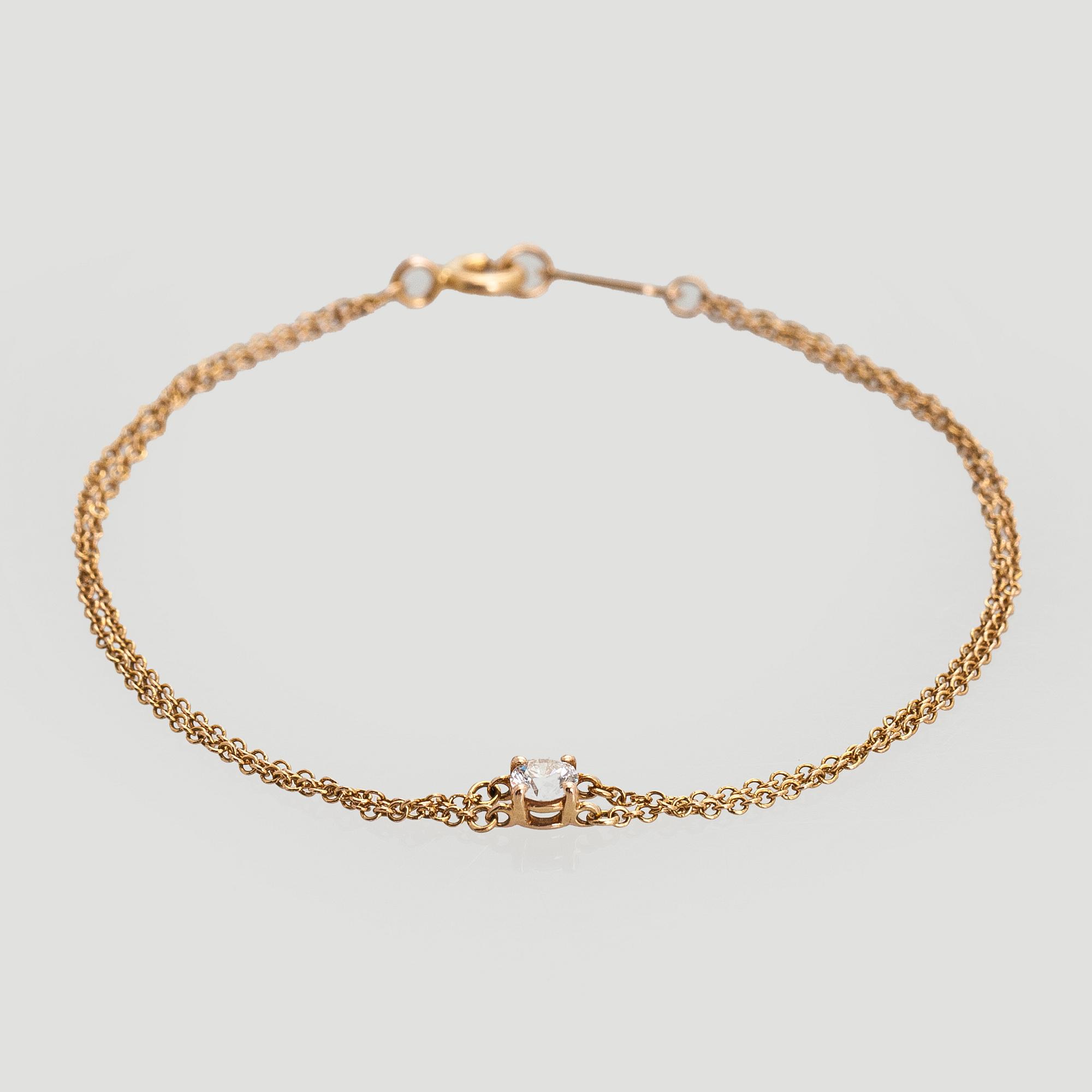 Tiffany & Co, armband, 18K guld med en briljantslipad diamant.