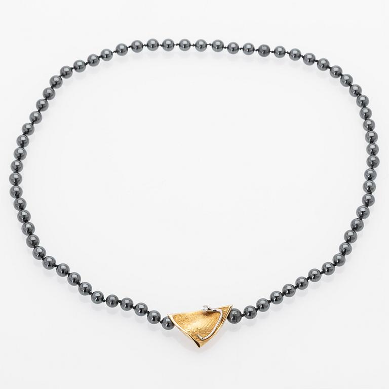 Ole Lynggaard, Hematite necklace with an 18K gold clasp and a diamond.