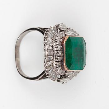 An emerald-cut emerald and baguette-cut diamond ring.