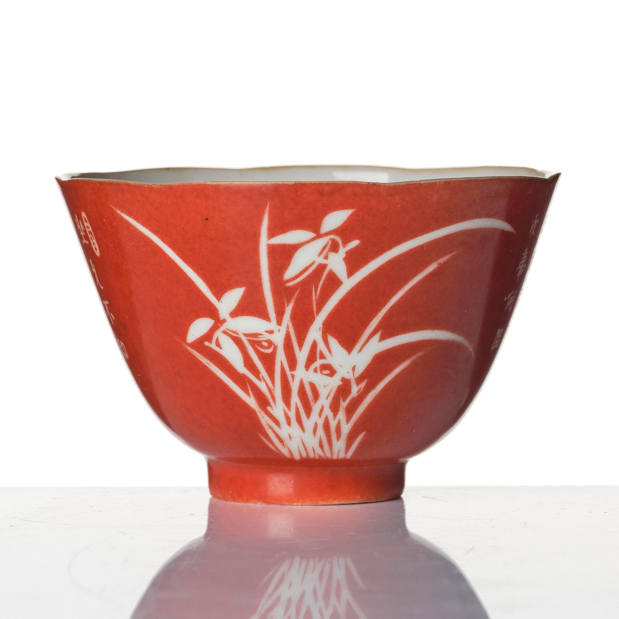 A coral-ground reserve decorated 'orchids' cup, late Qing dynasty.