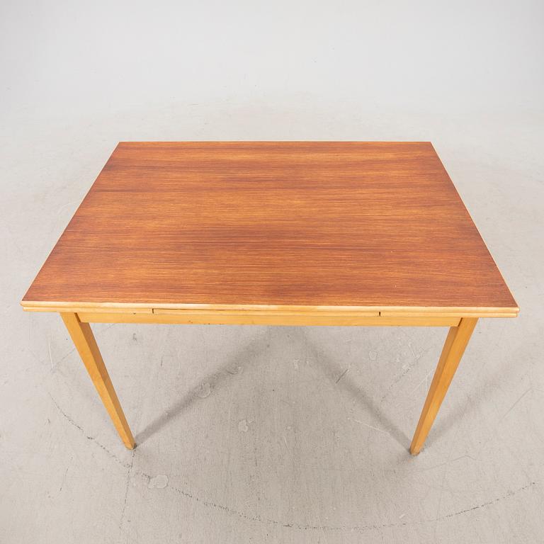 A 1960s teak and beech dining table.