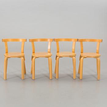 A TABLE AND FOUR CHAIRS DESIGNED BY ALVAR AALTO FOR ARTEK.