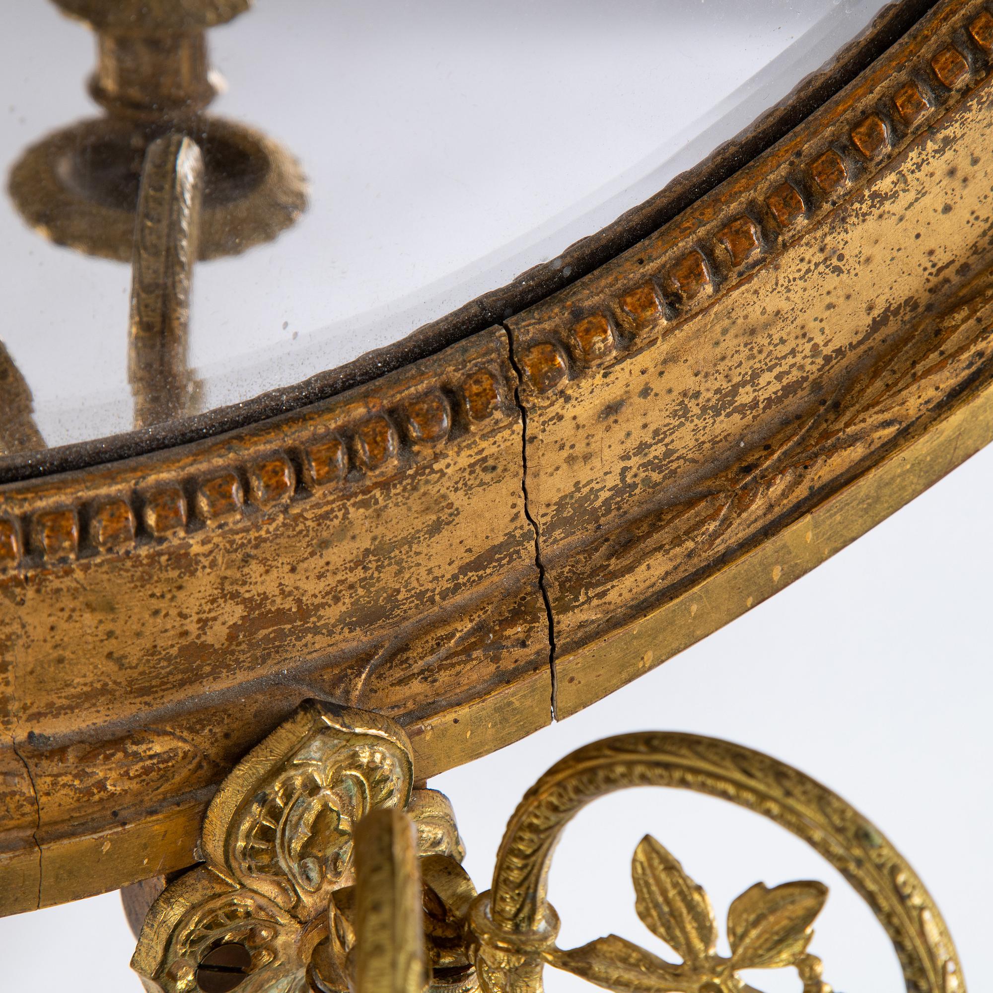 A Gustavian two-light girandole mirror, Stockholm, late 18th century.