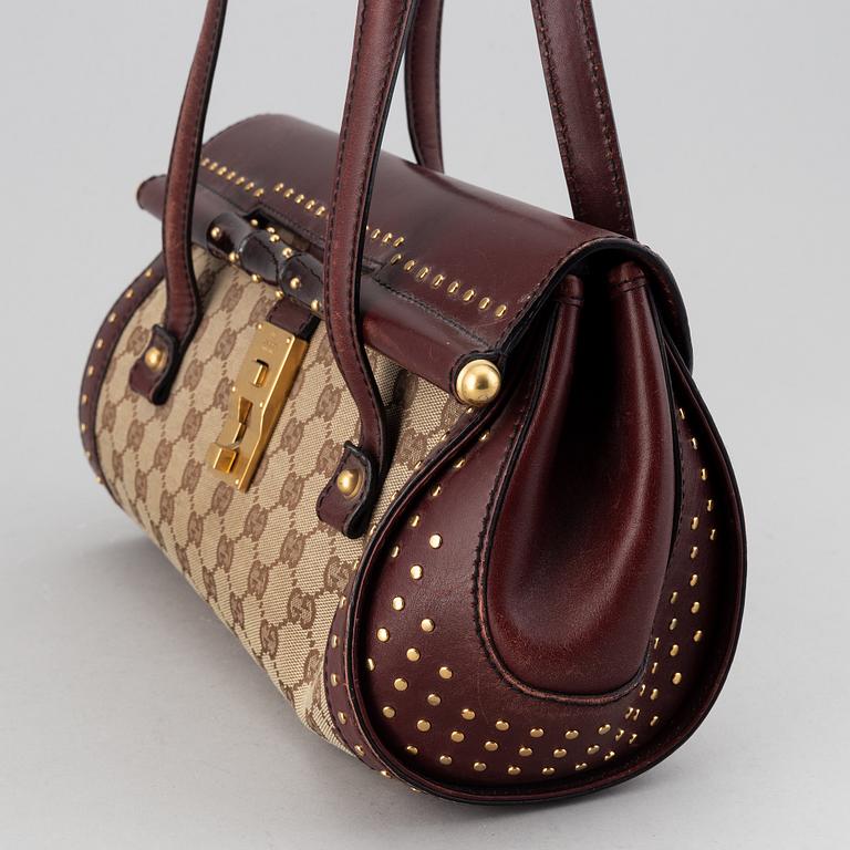 Gucci, a monogram canvas bag.