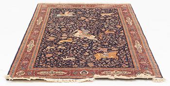 A carpet with hunting motives. 224 x 141 cm.