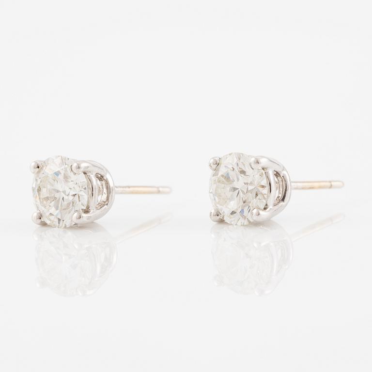 A pair of earrings in 18K white gold set with two round brilliant-cut diamonds, likely Tiffany & Co.