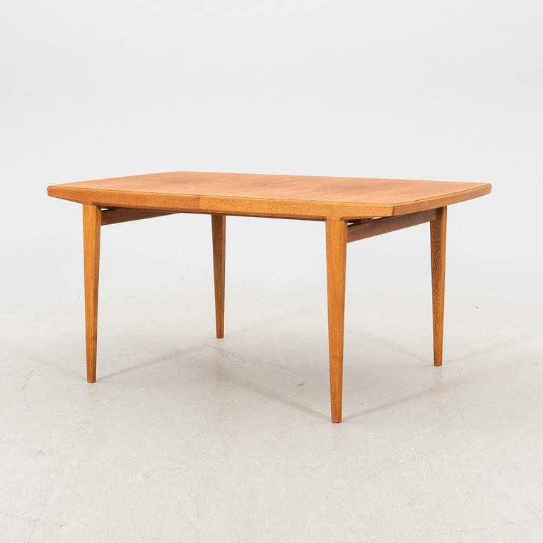 A 1950s teak dining table.