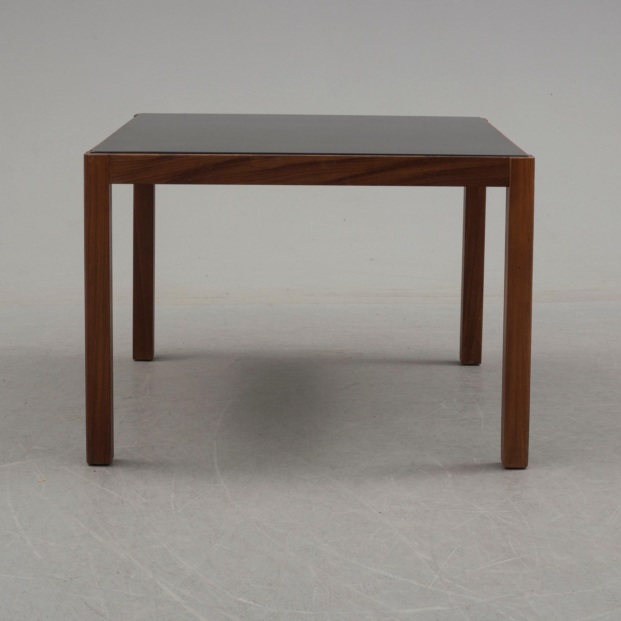 A 1960's teak coffee table with glass top.