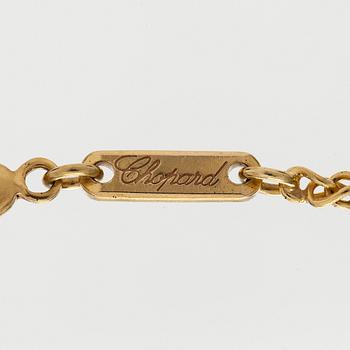 Chopard, an 18K gold 'Happy Diamonds' necklace with brilliant-cut diamonds.