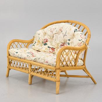 A rattan sofa and two armchairs, later part of the 20th century.