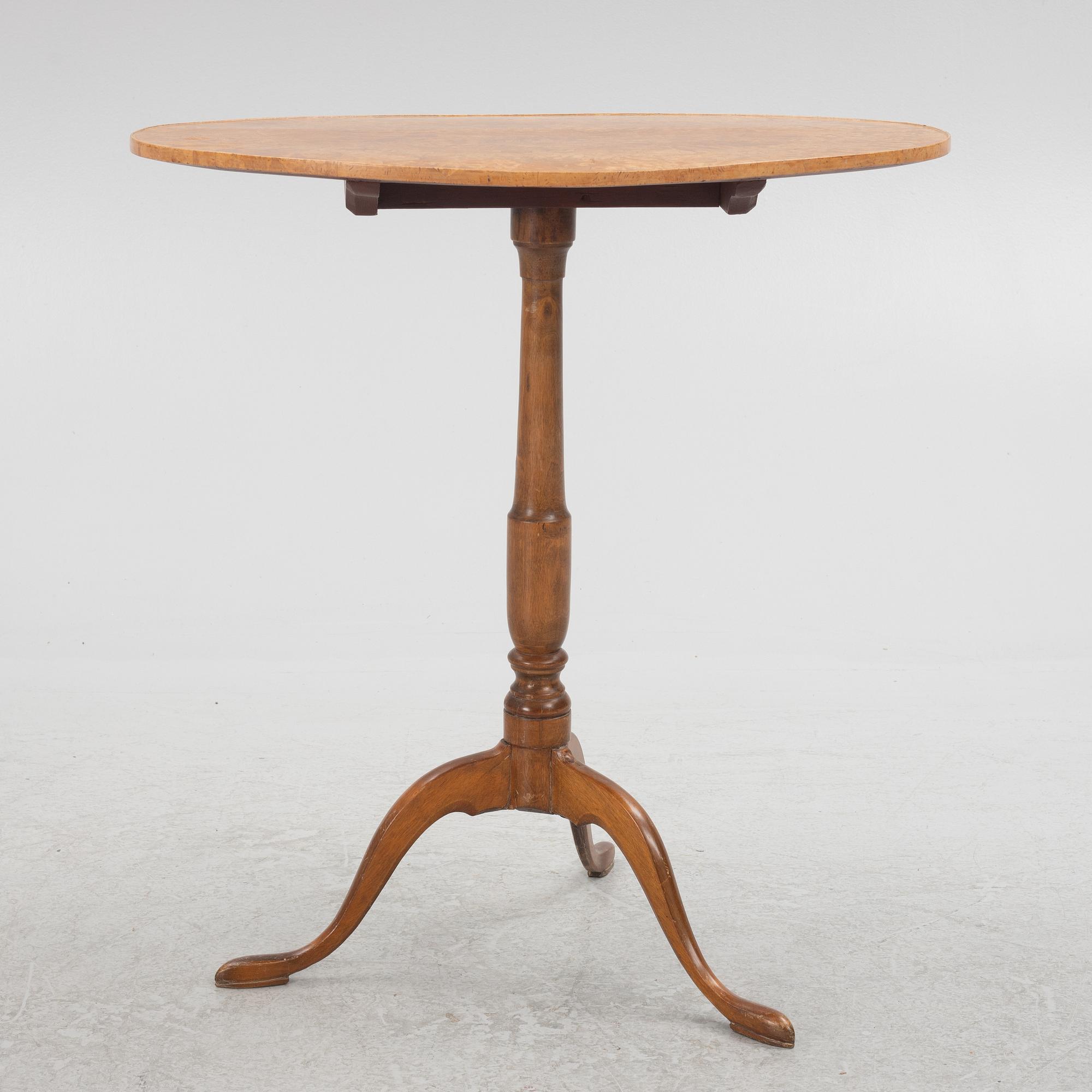 A 19th Century birch tilt top table.