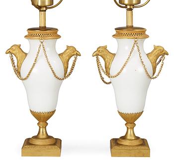 514. A pair of French circa 1800 gilt bronze and porcelain table lamps.